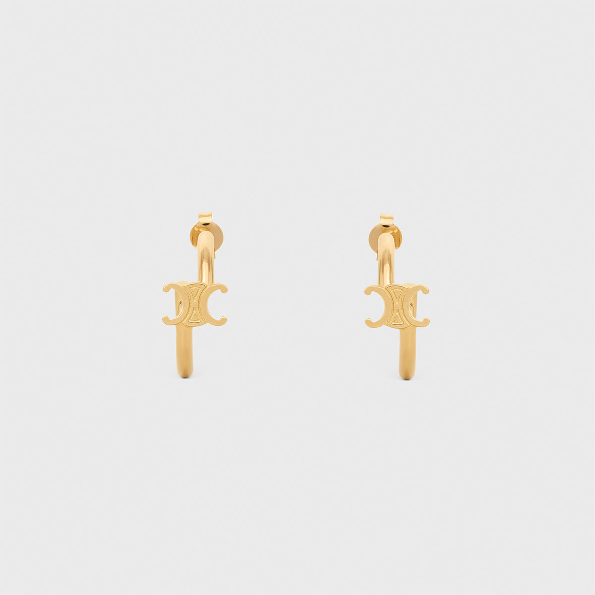 TRIOMPHE ASYMMETRIC HOOPS IN BRASS WITH GOLD FINISH