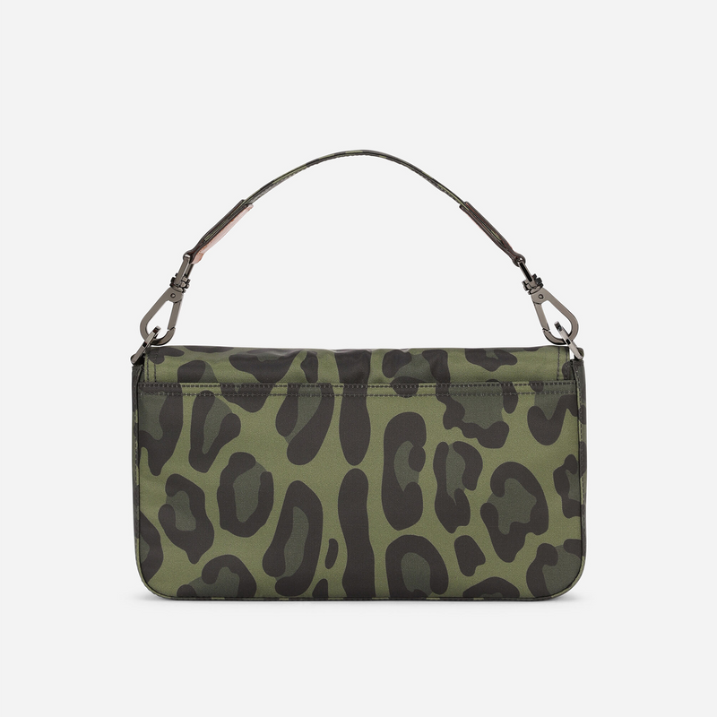 NYLON CROSSBODY BAG WITH LEOPARD PRINT AGAINST A GREEN BACKGROUND AND BRANDED PLATE